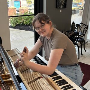 Emily Weaver RPT Emily Weaver, Steinway piano technician working on a Steinway model M grand.
